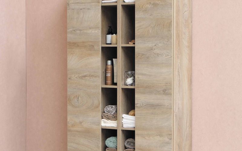 Large round mirror and modern pendant lighting creating illusion of space in compact living area