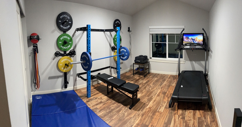 Home gym workout space showing adjustable dumbbells resistance bands and exercise equipment for effective home training programs - home fitness setup InfoProds 2026