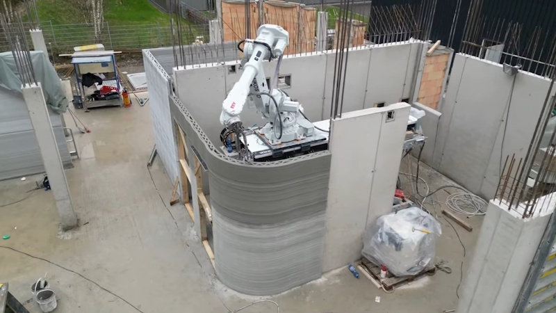 Large-scale 3D printer creating concrete building walls layer by layer demonstrating revolutionary construction technology