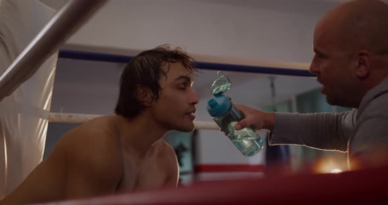 Sports nutritionist and athletic trainer monitoring professional boxer hydration levels body composition and weight cutting progress using scientific equipment and biomarkers during fight week preparation championship bout InfoProds 2026