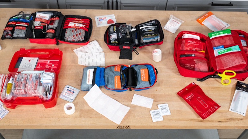 Realistic car emergency kit focused on actual survival scenarios showing proper cold weather sleeping bag thermal blankets and essential supplies not generic Amazon lists - InfoProds 2026