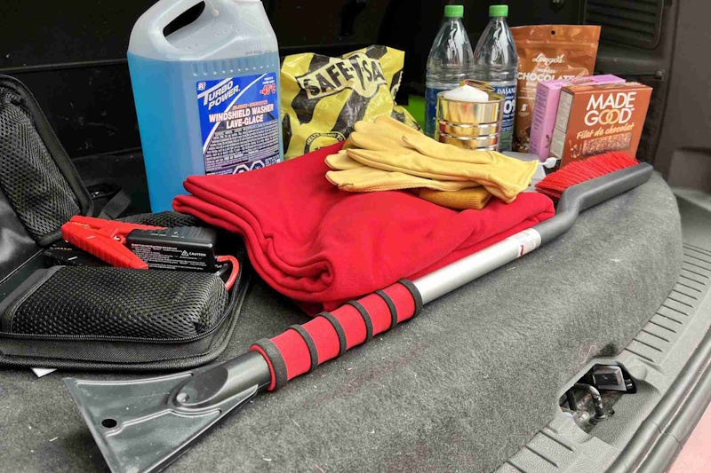 Vehicle stranded in winter storm showing critical importance of proper emergency kit with cold rated sleeping bag hand warmers and winter survival supplies - InfoProds 2026