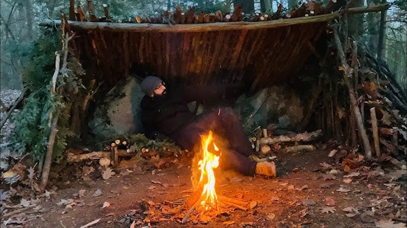 Overnight wilderness survival showing shelter fire warmth management and psychological resilience techniques during extended lost emergency - InfoProds 2026