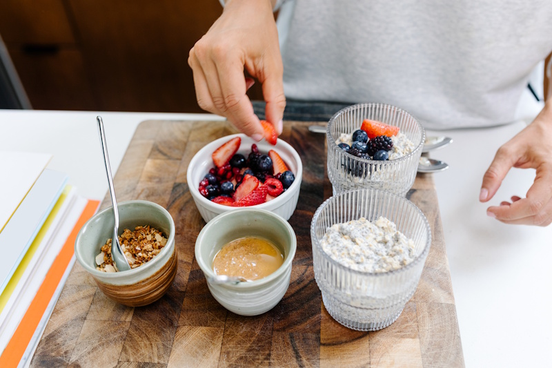 Person preparing nutritious balanced breakfast after restful night sleep showing healthy lifestyle habits for sustainable weight loss and fat burning success - InfoProds 2026