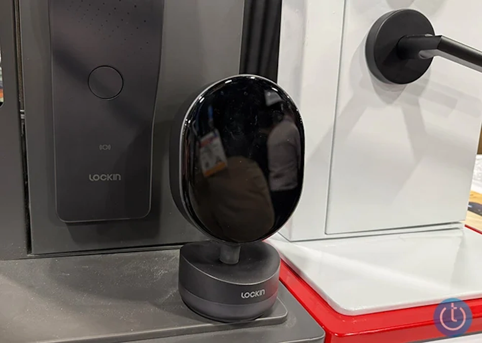 Modern optical charging smart lock installation showing wireless power transmitter unit mounted on interior wall beaming infrared light energy to photovoltaic receiver panel integrated into door lock exterior housing, demonstrating battery-free home security technology for maintenance-free keyless entry systems in contemporary residential settings - InfoProds 2026