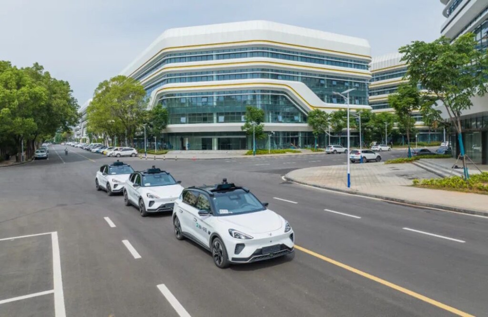 Baidu Apollo Go autonomous robotaxi vehicles with advanced sensor arrays operating on modern Chinese city streets, demonstrating large-scale deployment of self-driving technology in urban environment with smart infrastructure integration - InfoProds autonomous vehicle comparison 2026