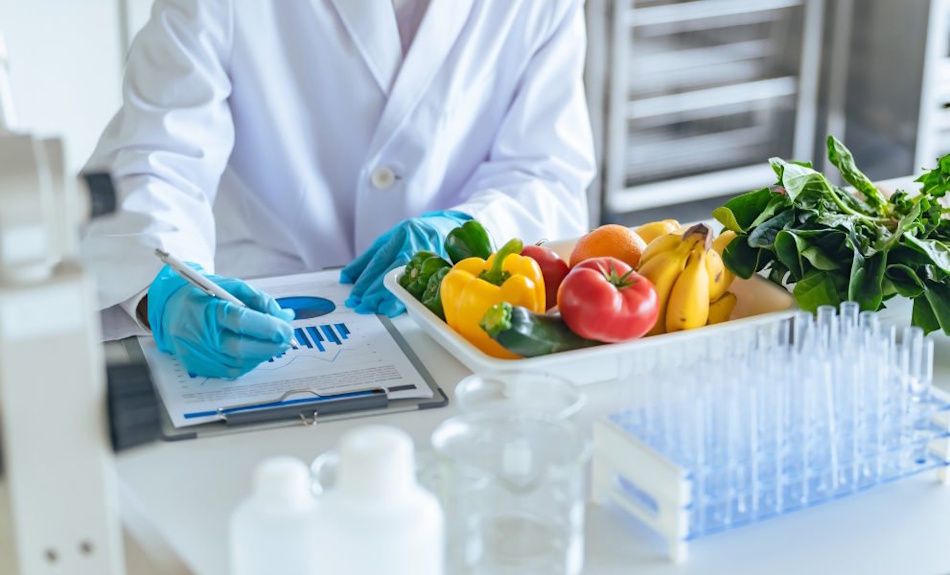 Fresh vegetables including broccoli carrots and peppers arranged on laboratory testing table with scientific equipment for nutritional analysis comparing fresh frozen and canned ingredients - InfoProds Kitchen Science 2026