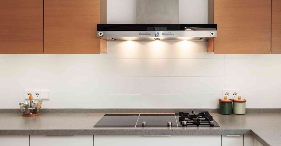 Professional stainless steel range hood ventilation system installed above modern cooking surface demonstrating proper kitchen exhaust solution for removing nitrogen dioxide carbon monoxide and other combustion pollutants from gas stoves as recommended by Stanford research and EPA indoor air quality guidelines - InfoProds 2026 Kitchen Safety