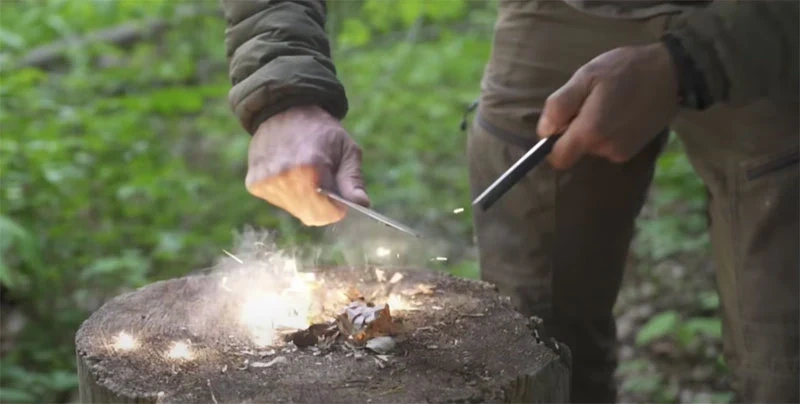 Person practicing essential fire-starting survival skills using ferro rod and natural tinder in backyard training environment demonstrating practical weekend learning - InfoProds 2026