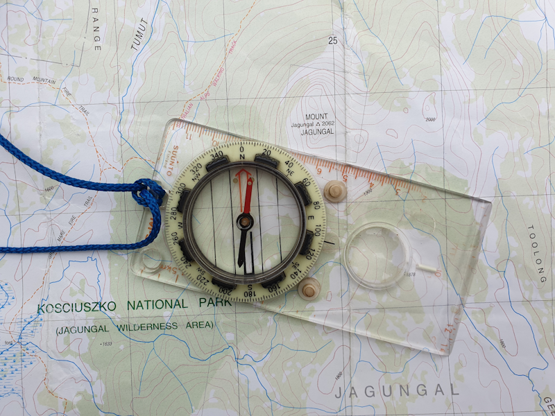 Navigation training with topographic map and compass showing bearings route planning and terrain association skills essential for wilderness survival and emergency situations - InfoProds 2026