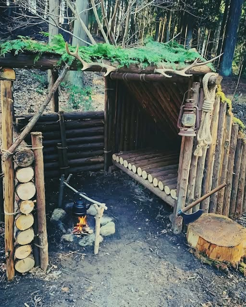 Complete backyard survival camp setup featuring fire pit emergency shelter organized gear and training area demonstrating comprehensive weekend survival skills practice - InfoProds 2026