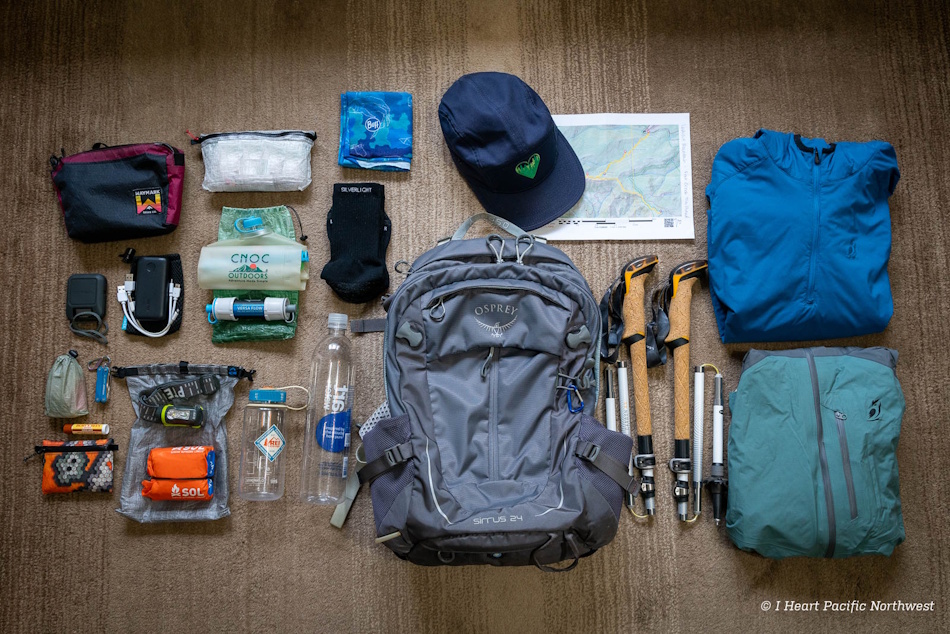 Hiker wearing protective wide-brimmed hat and lightweight light-colored moisture-wicking clothing for summer heat protection during mountain trail hiking, demonstrating proper gear selection and clothing strategies to prevent heatstroke and maximize cooling efficiency - InfoProds 2026
