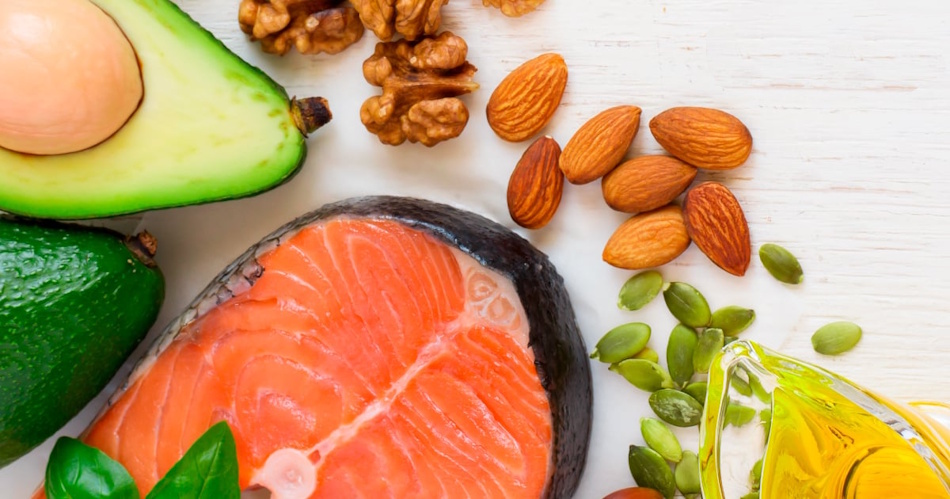 Beautifully styled presentation of wild-caught salmon fillet, sliced avocado, walnuts, chia seeds, and flaxseed displaying essential omega-3 fatty acid sources that reduce inflammation maintain skin moisture barrier and promote youthful radiant complexion - InfoProds 2026