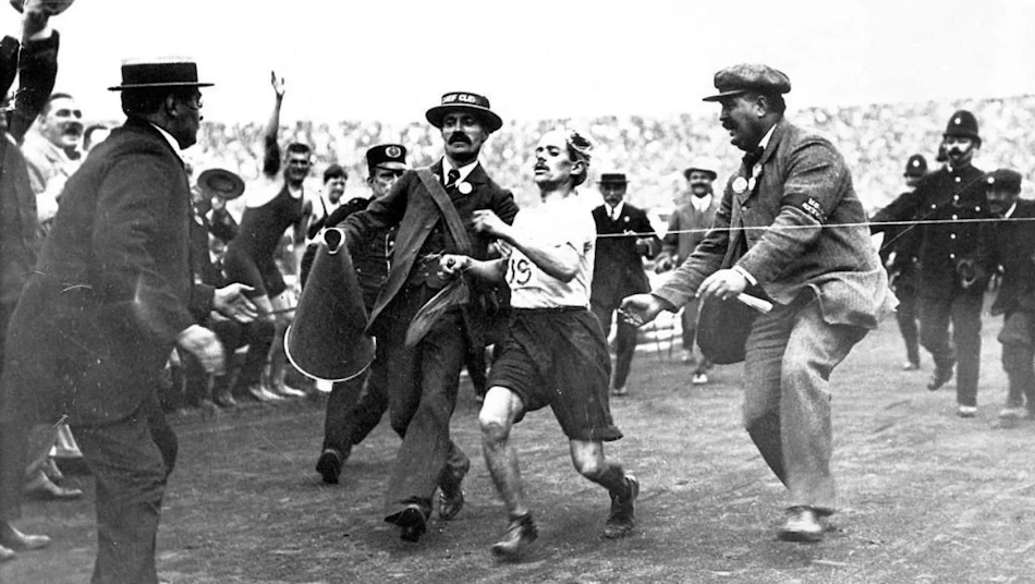 Historical Olympic Games track and field 100-meter sprint finish showing evolution of finish line technique through decades of championship competition - Olympic athletics history InfoProds 2026