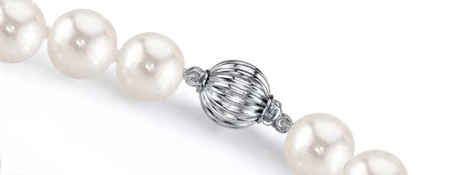Elegant box clasp with figure-eight safety latch on white pearl strand necklace demonstrating interlocking mechanism and redundant security features used in valuable fine jewelry pieces - InfoProds 2026