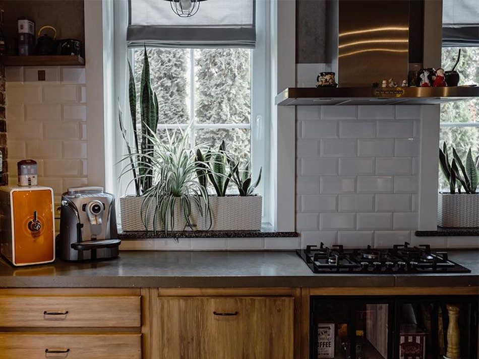 Contemporary residential kitchen with gas stove and no visible range hood exhaust system showing the hidden indoor air quality crisis from cooking emissions that causes respiratory illness in families across America - Kitchen Ventilation Failure Health Risks InfoProds 2026