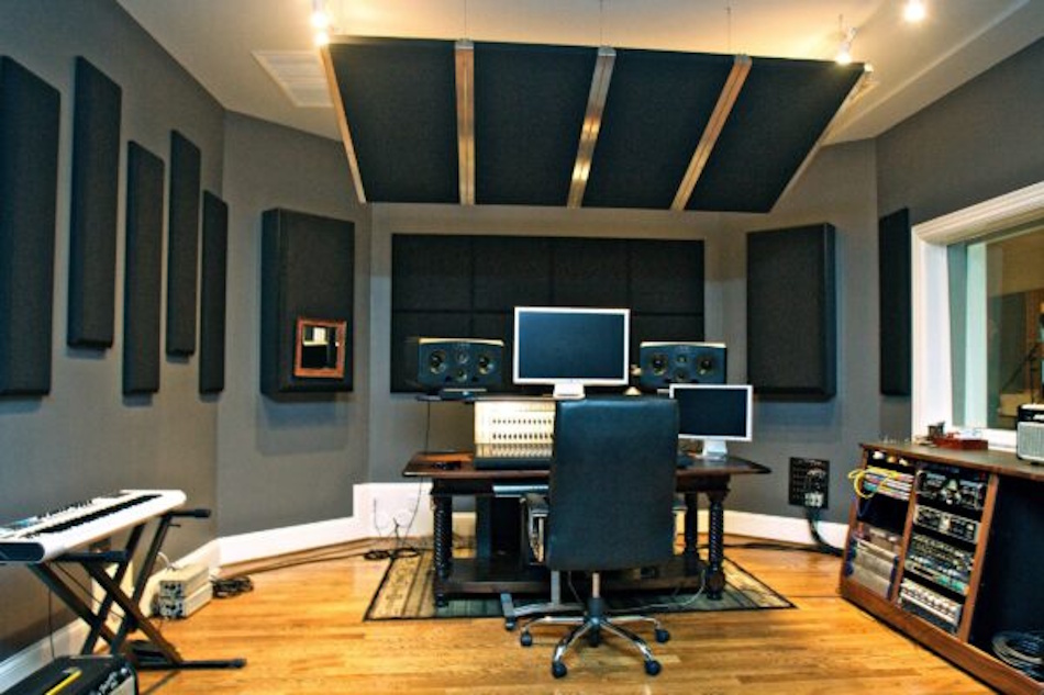 Professional home recording studio interior featuring comprehensive acoustic treatment including bass traps, absorption panels, and diffusers demonstrating military-grade soundproofing principles applied to residential space, showing multi-layer approach combining sound blocking barriers with strategic absorption for complete noise isolation - InfoProds 2026