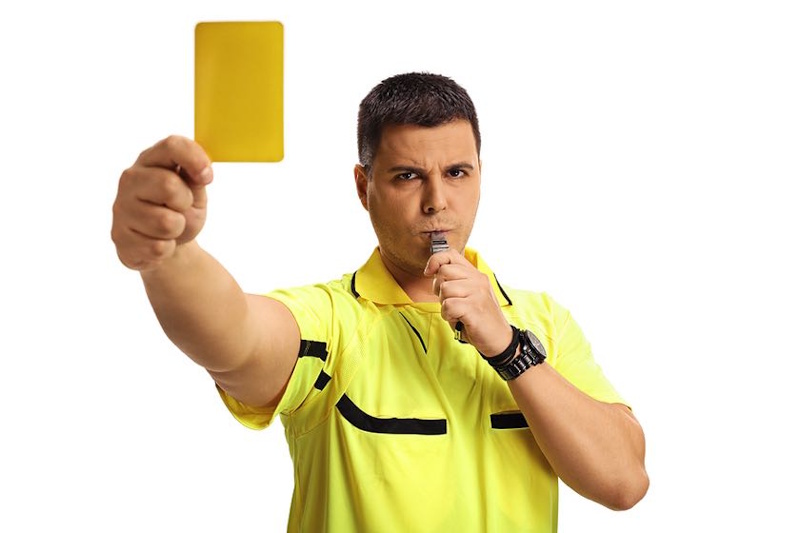 Soccer tactical fouling professional foul showing defender deliberately stopping counterattack accepting yellow card punishment as legal strategic decision in modern football - InfoProds 2026