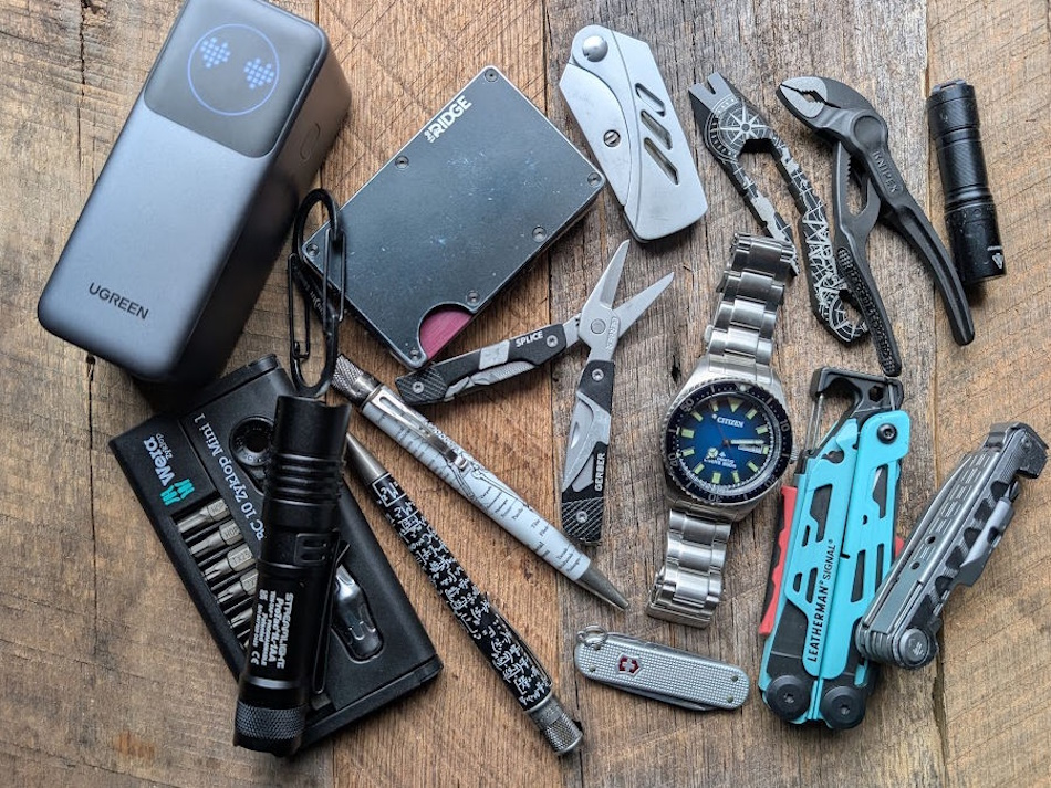 Organized everyday carry EDC essentials including multi-tool knife flashlight first aid kit paracord emergency supplies laid out on tactical background showing professional preparedness gear for office car hiking scenarios - InfoProds 2026