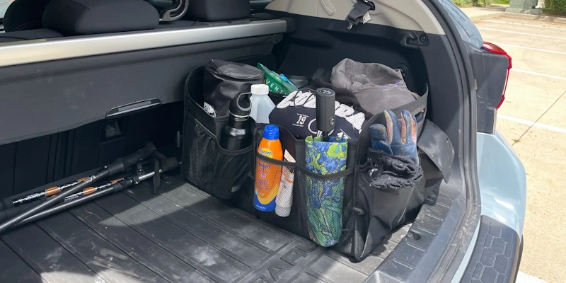 Comprehensive car trunk organization system with collapsible organizer, cargo nets, and properly zoned storage compartments showing clean, accessible storage solutions for vehicle accessories and emergency supplies - InfoProds 2026
